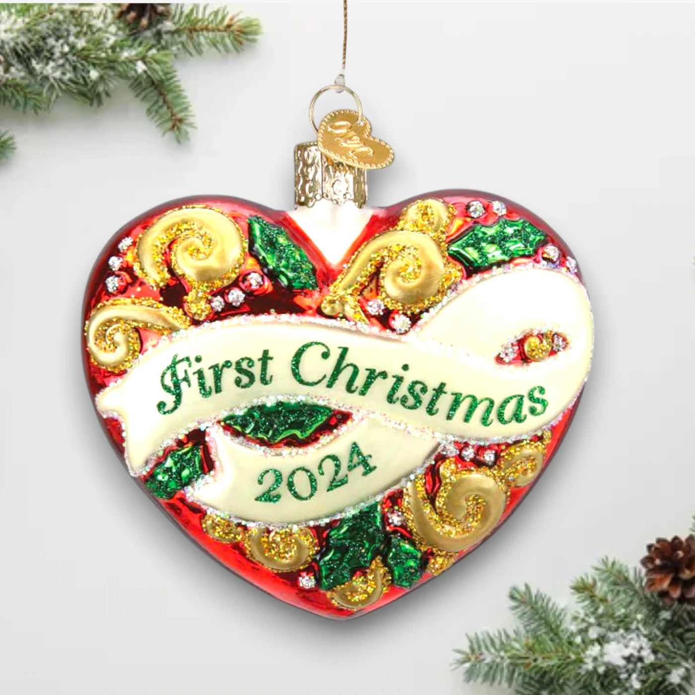 2024 First Christmas Heart Ornament featuring a vibrant red heart with gold accents, glitter details, and “First Christmas 2024” lettering across a white banner.