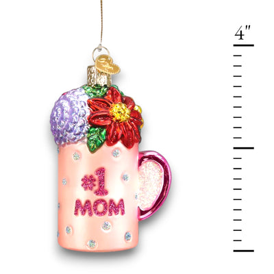 Pink “#1 Mom” mug Christmas ornament with glitter accents and colorful floral decorations, customizable with name and year.