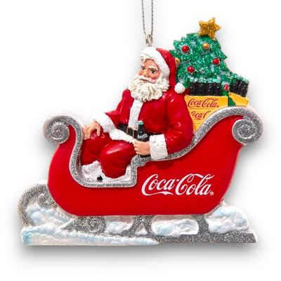 Back view of the Coca-Cola Santa in Sleigh ornament showing detailed Christmas tree and Coca-Cola bottle designs in the sleigh.