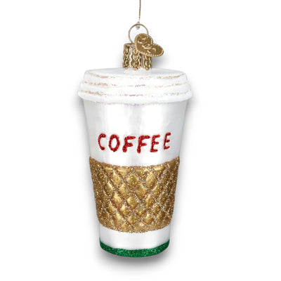 Christmas ornament shaped like a to-go coffee cup with a gold glitter sleeve and bold red “COFFEE” lettering.