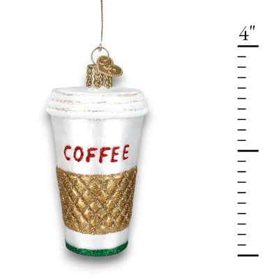 Christmas ornament shaped like a to-go coffee cup with a gold glitter sleeve and bold red “COFFEE” lettering.