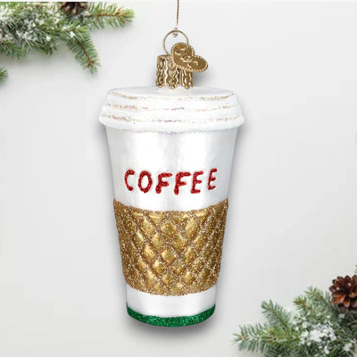 Christmas ornament shaped like a to-go coffee cup with a gold glitter sleeve and bold red “COFFEE” lettering.