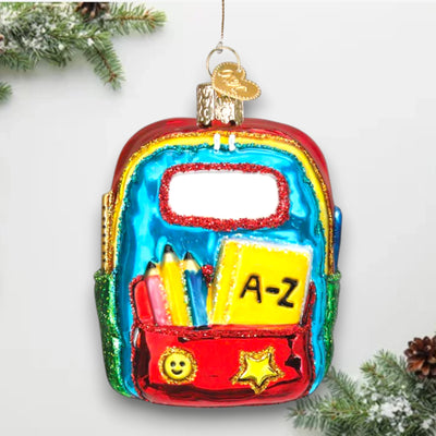 Personalized First Day Of School Christmas Ornament featuring a colorful backpack with school supplies, customizable with a name and year.