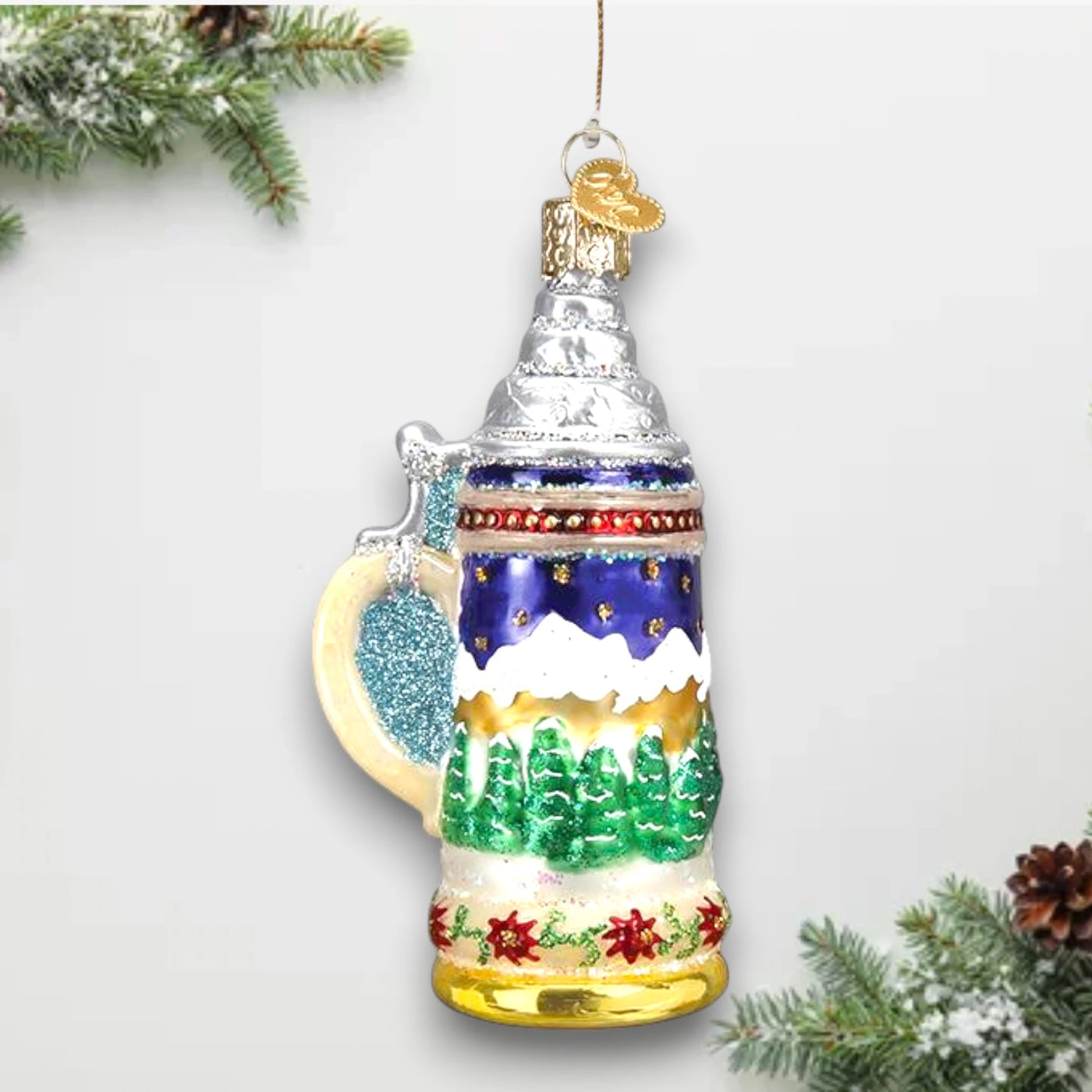 German Stein Christmas ornament featuring a traditional beer stein design with an Alpine scene, silver lid, and festive glitter accents.