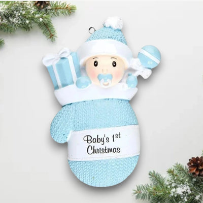 Personalized Baby Boy In Mitten Ornament with blue knit pattern, baby boy in winter hat and pacifier, customizable with name and year.