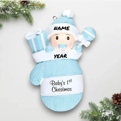 Personalized Baby Boy In Mitten Ornament with blue knit pattern, baby boy in winter hat and pacifier, customizable with name and year.