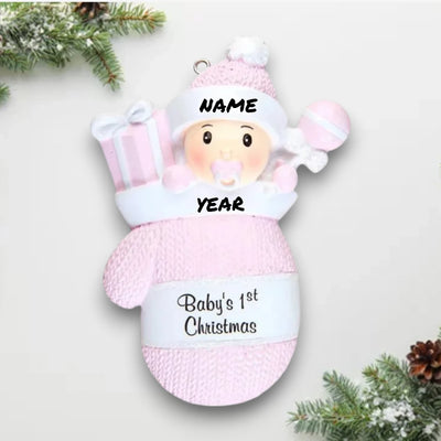 Personalized Baby Girl In Mitten Ornament with pink knit pattern, baby girl in winter hat and pacifier, customizable with name and year.