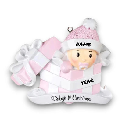 Personalized Baby Girl In Present Ornament with pink knit hat, peeking from a pink and white gift box, customizable with name and year.