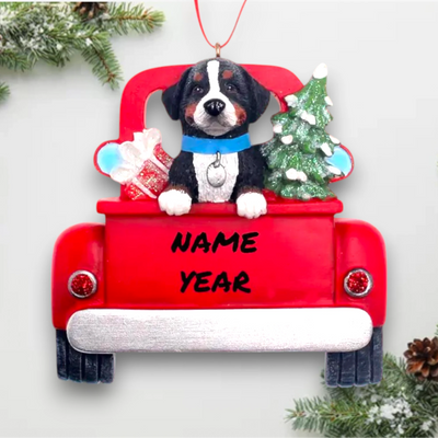 Personalized Bernese Mountain Dog In Back Of Truck Christmas Ornament featuring a Bernese Mountain Dog, festive red truck, Christmas tree, and gift, customizable with name and year.
