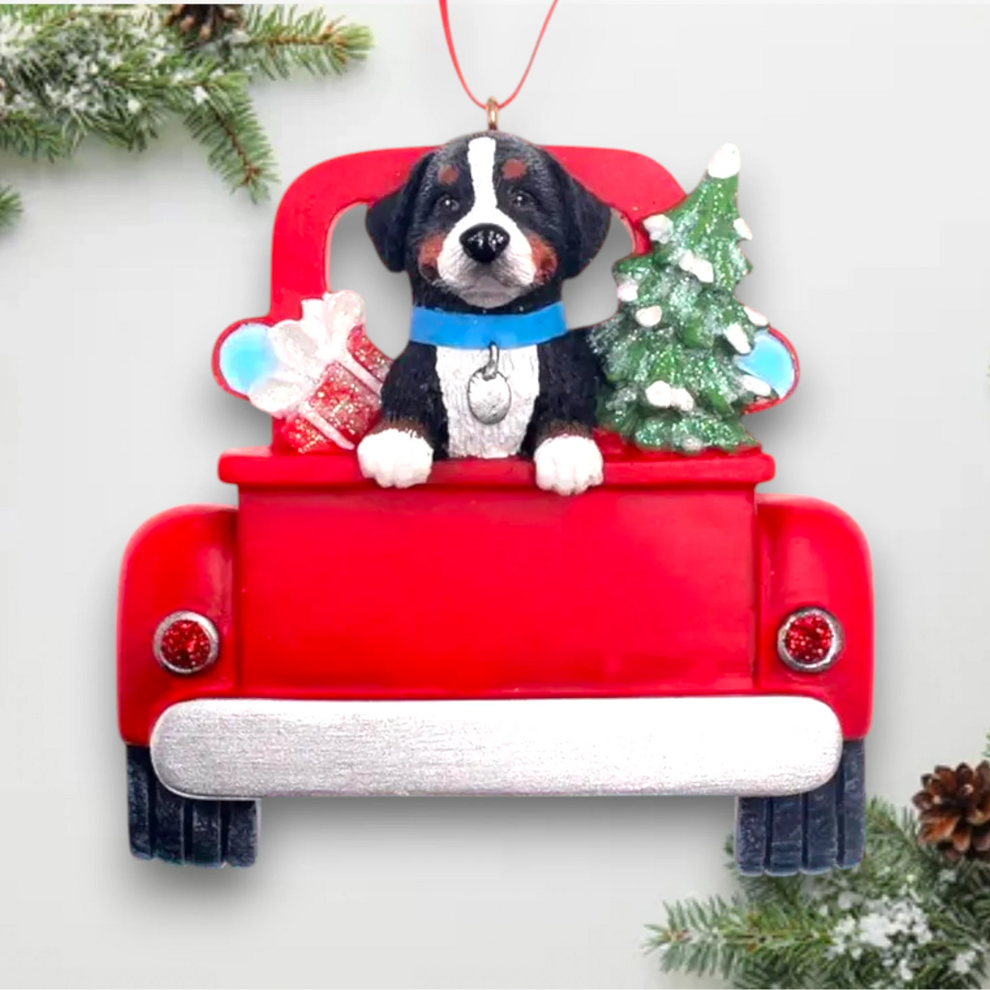 Personalized Bernese Mountain Dog In Back Of Truck Christmas Ornament featuring a Bernese Mountain Dog, festive red truck, Christmas tree, and gift, customizable with name and year.
