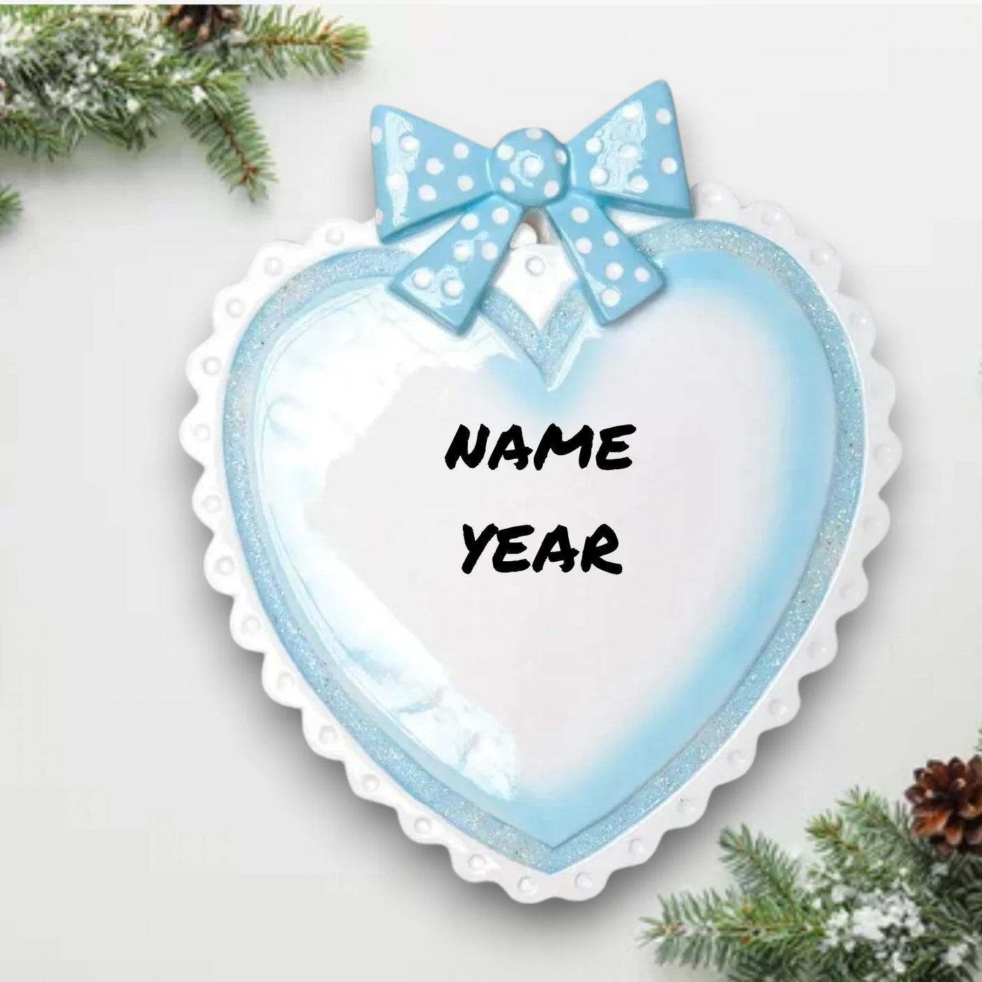 Personalized Blue Baby Heart Christmas Ornament with customizable name and year, adorned with a blue polka-dot bow.