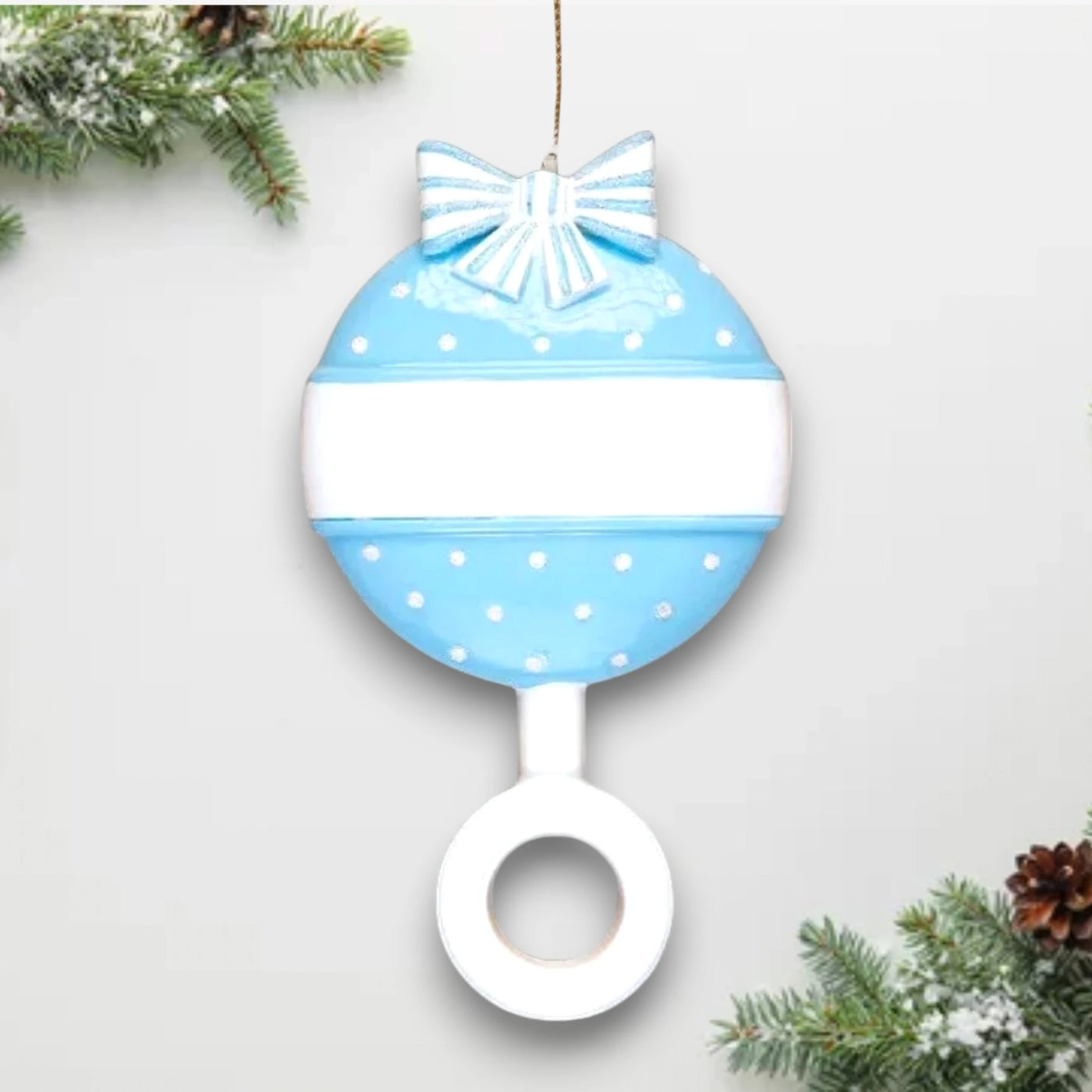 Personalized Blue Baby Rattle Christmas Ornament with customizable name and year, decorated with polka dots and a bow.