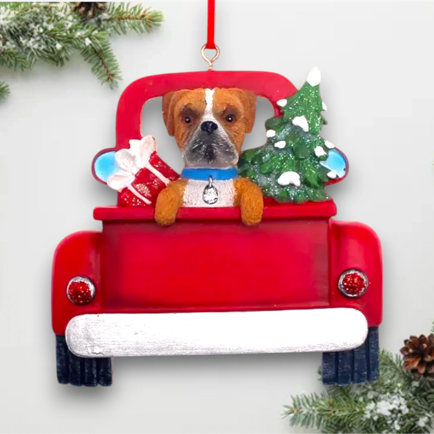 Personalized Boxer In Back Of Truck Christmas Ornament featuring a Boxer, festive Christmas tree, and holiday gifts in a red truck with customizable name and year.
