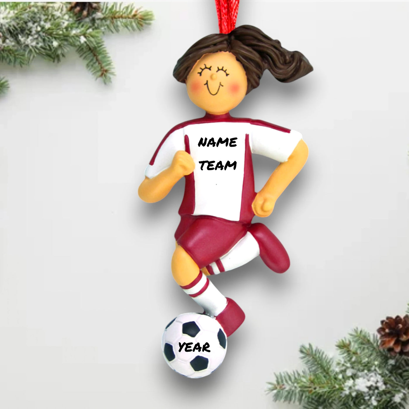 Personalized Brunette Female Dribbling Soccer Ornament in Red Uniform, customizable with name, team, and year.