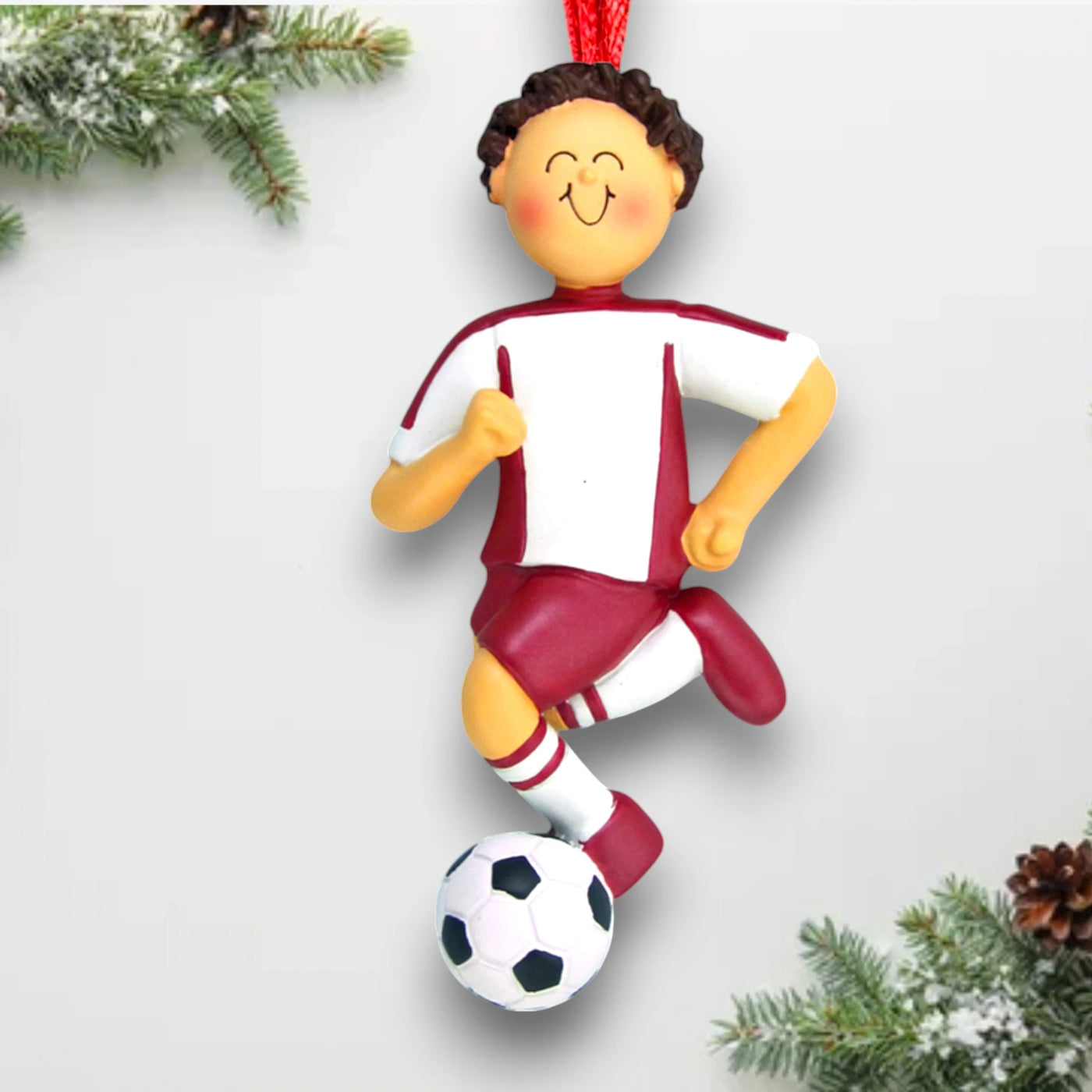 Personalized Brunette Male Soccer Ornament with Red Uniform, dribbling a soccer ball, customizable with name and year.