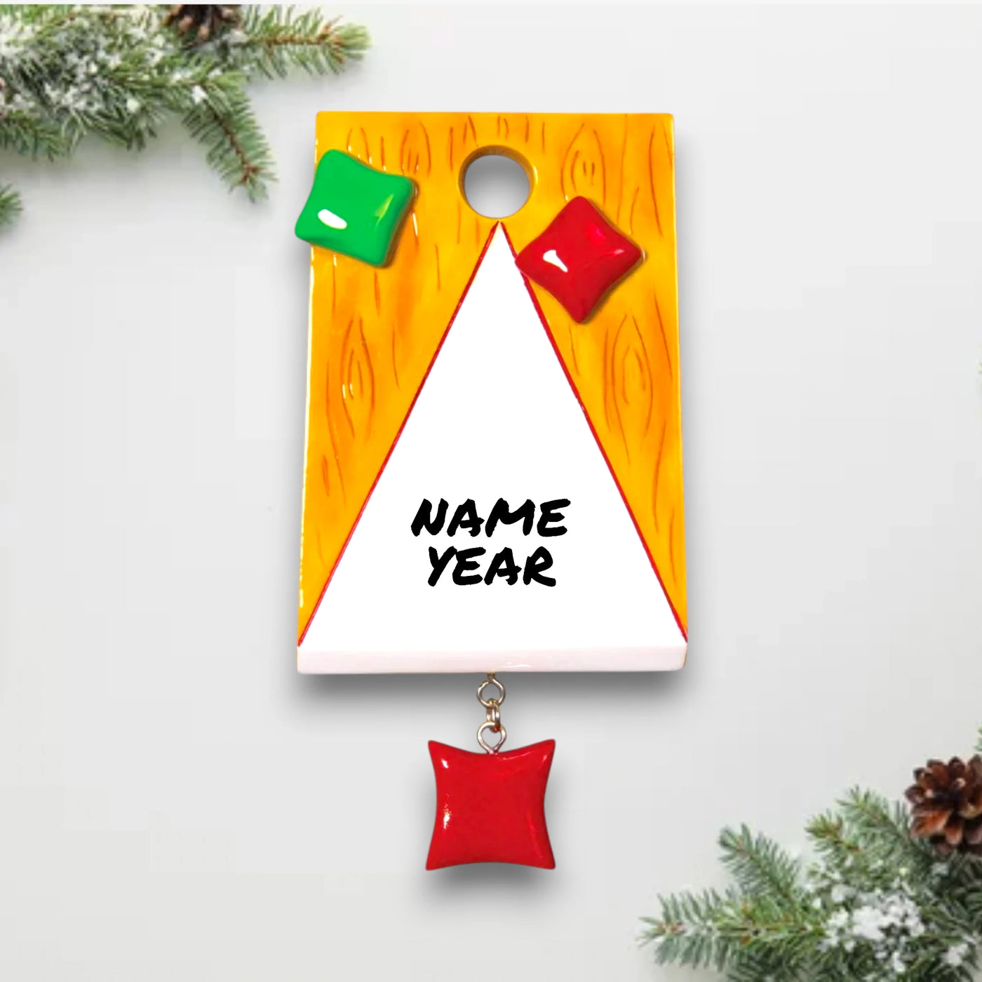  Personalized Corn Hole Bag Toss Christmas Ornament with customizable name, featuring a mini corn hole board and colorful bean bags.
