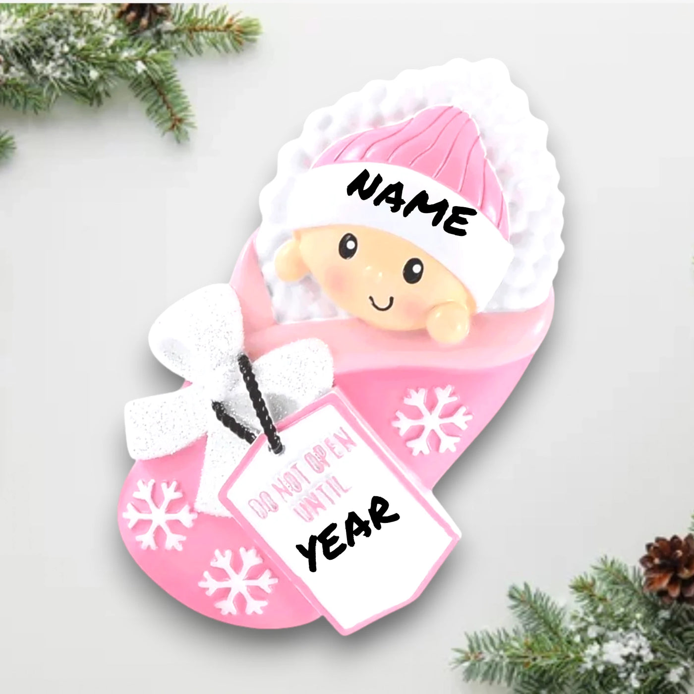 Personalized Do Not Open Until Pink Christmas Ornament with customizable name and year, featuring a baby girl in a cozy pink blanket with snowflake details.