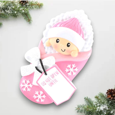 Personalized Do Not Open Until Pink Christmas Ornament with customizable name and year, featuring a baby girl in a cozy pink blanket with snowflake details.