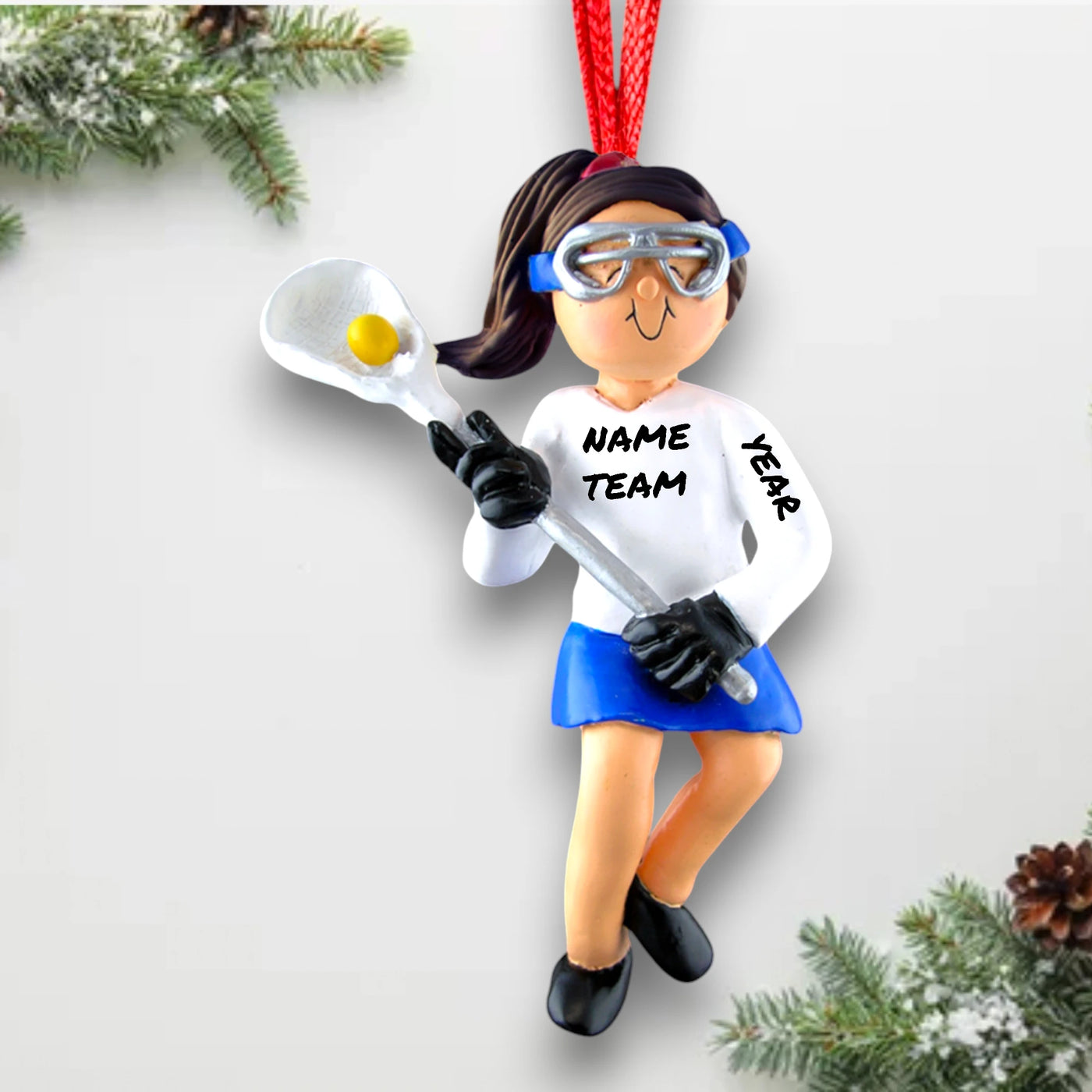 Personalized Female Lacrosse Ornament featuring a brunette player in uniform with a lacrosse stick, customizable with name, team, and year.