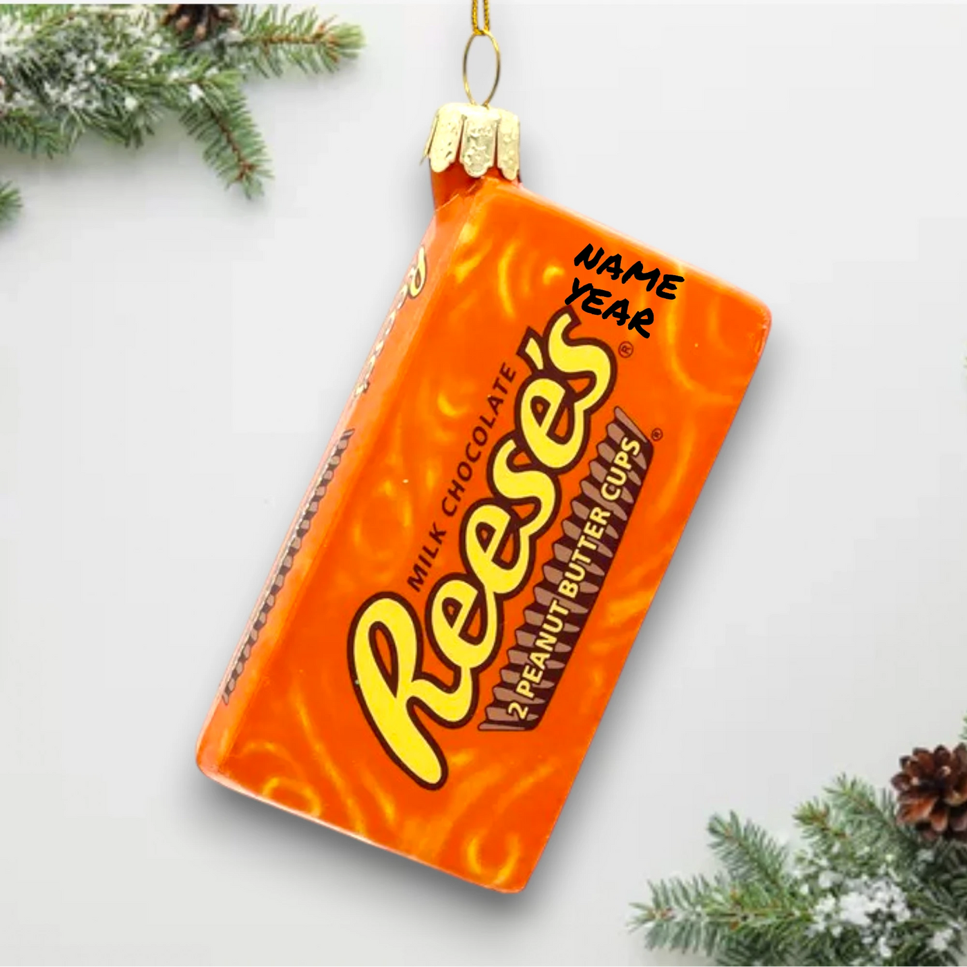 Personalized Glass Reese's Chocolate Christmas Ornament resembling the iconic orange wrapper with bold lettering.

