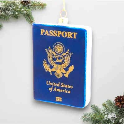 Personalized Glass Passport Christmas Ornament featuring a blue U.S. passport design with gold detailing.
