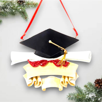 Personalized graduation ornament with a black mortarboard cap, gold tassel, diploma scroll, and customizable ribbon banner.
