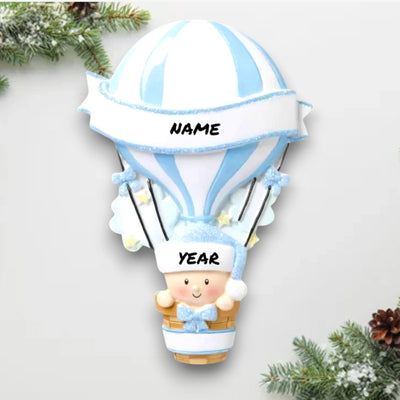 Personalized Hot Air Balloon Blue Baby’s First Christmas Ornament featuring a blue and white striped balloon with baby in basket, customizable with name and year.