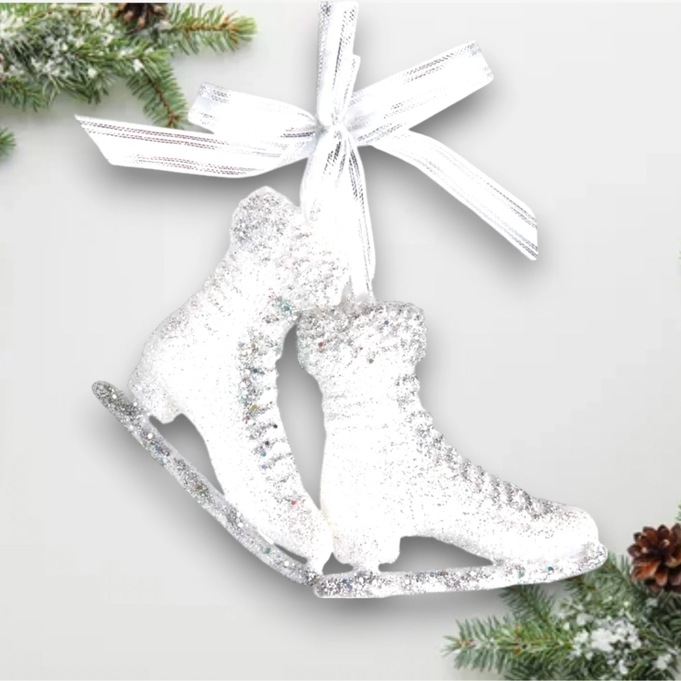 Personalized Ice Skates With Glitter Christmas Ornament featuring a pair of white ice skates adorned with glitter and a silver ribbon, customizable with a name and year.
