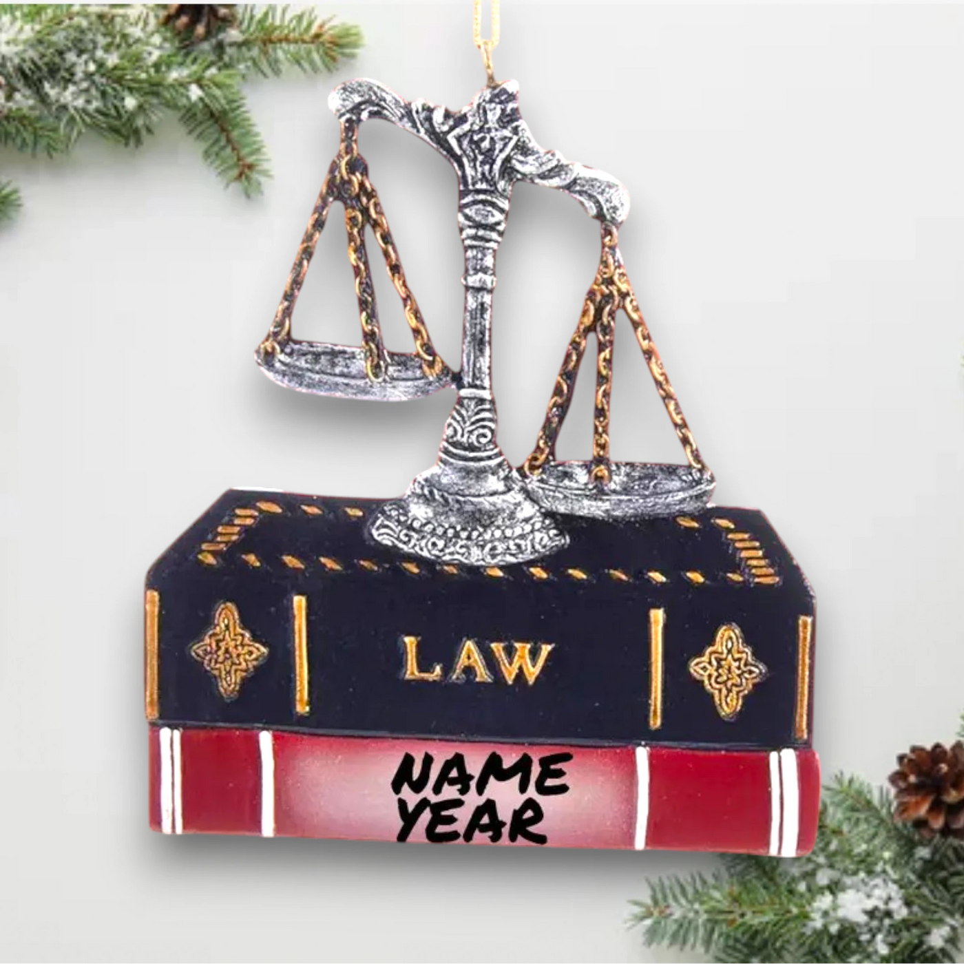 Personalized Lawyer Ornament with scales of justice resting on a law book, customizable with name and year.
