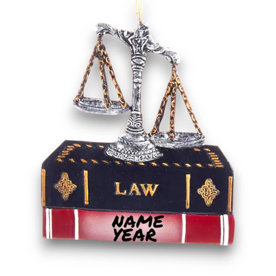 Personalized Lawyer Ornament with scales of justice resting on a law book, customizable with name and year.
