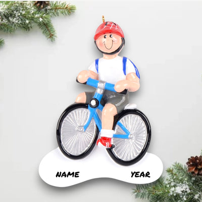 Personalized Little Boy Bike Christmas Ornament featuring a boy riding a blue bike with a red helmet and a backpack, customizable with name and year.
