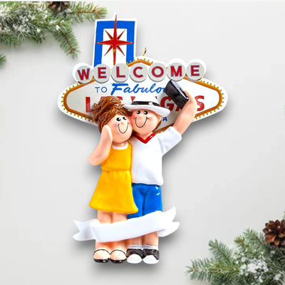 Personalized LOVE IN LAS VEGAS Christmas Ornament featuring a couple in front of the “Welcome to Fabulous Las Vegas” sign with customizable names and year.