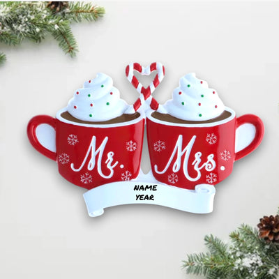 Personalized Mr. & Mrs. Hot Cocoa Christmas Ornament with customizable names and year, featuring two red mugs topped with whipped cream and a candy cane heart.
