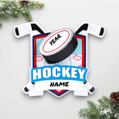 Personalized New Hockey Shield Christmas Ornament with a shield design, hockey sticks, puck, and customizable name and year.