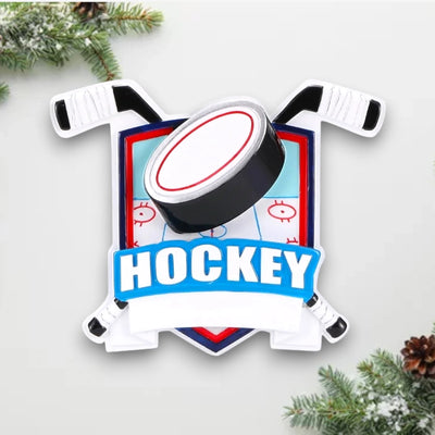 Personalized New Hockey Shield Christmas Ornament with a shield design, hockey sticks, puck, and customizable name and year.