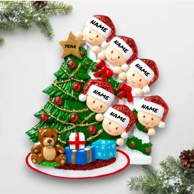 Personalized Peeking Family of 6 Christmas Ornament with customizable names and year, featuring family members peeking around a decorated Christmas tree with gifts and a teddy bear.

