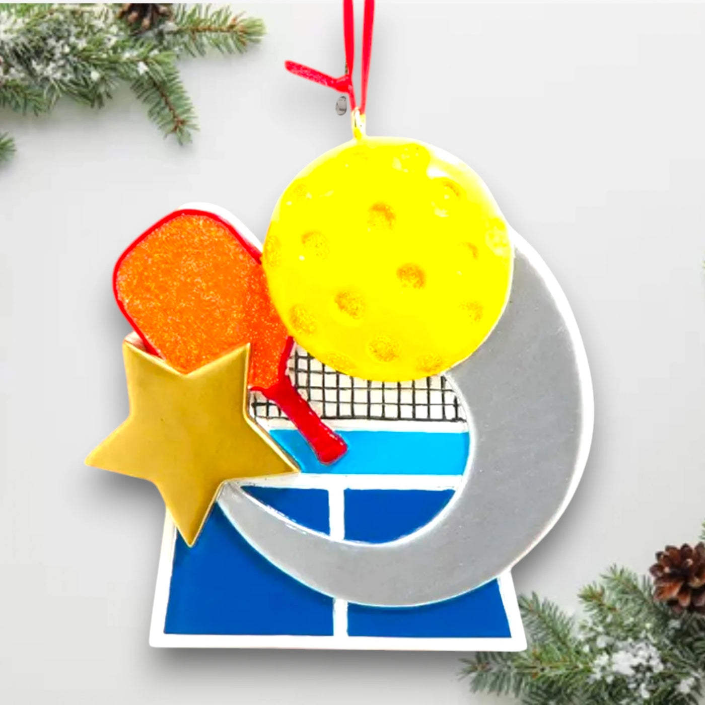 Personalized pickleball ornament featuring a paddle, yellow ball, and court graphic with customizable space for name and year.
