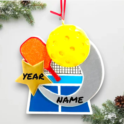 Personalized pickleball ornament featuring a paddle, yellow ball, and court graphic with customizable space for name and year.
