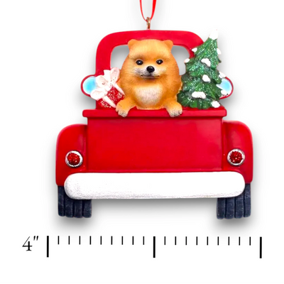 Personalized Pomeranian In Back Of Truck Christmas Ornament featuring a Pomeranian, festive Christmas tree, and holiday gifts in a red truck with customizable name and year.
