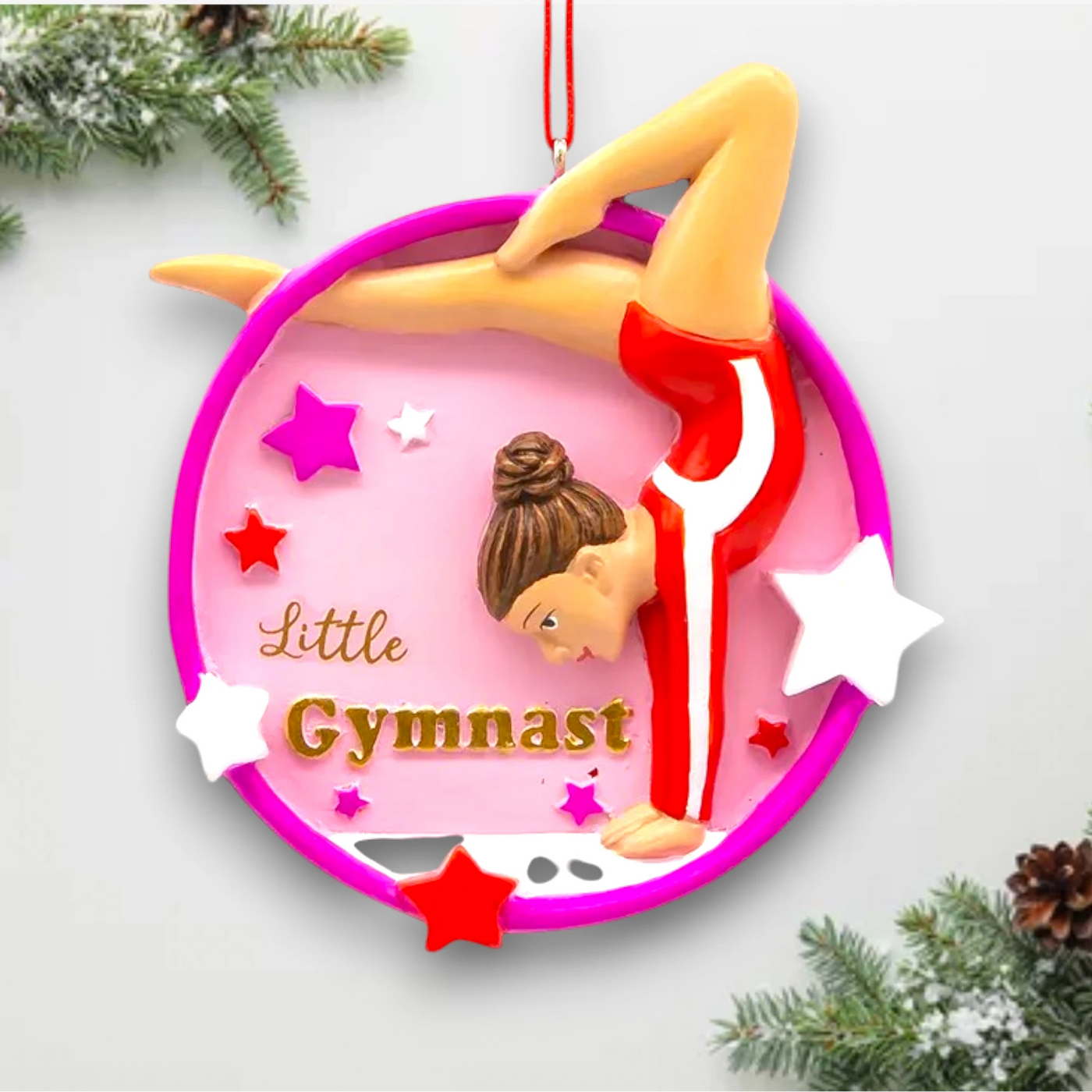 Personalized Little Gymnast Christmas Ornament featuring a gymnast in a red leotard, pink circular frame, and colorful star accents with customizable name and year.

