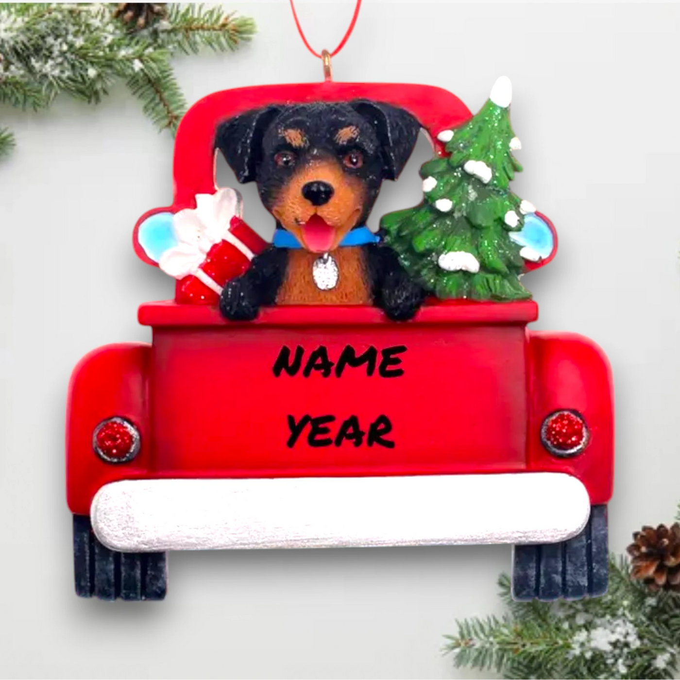 Personalized Rottweiler In Back Of Truck Christmas Ornament featuring a Rottweiler, festive red truck, Christmas tree, and gift, customizable with name and year.
