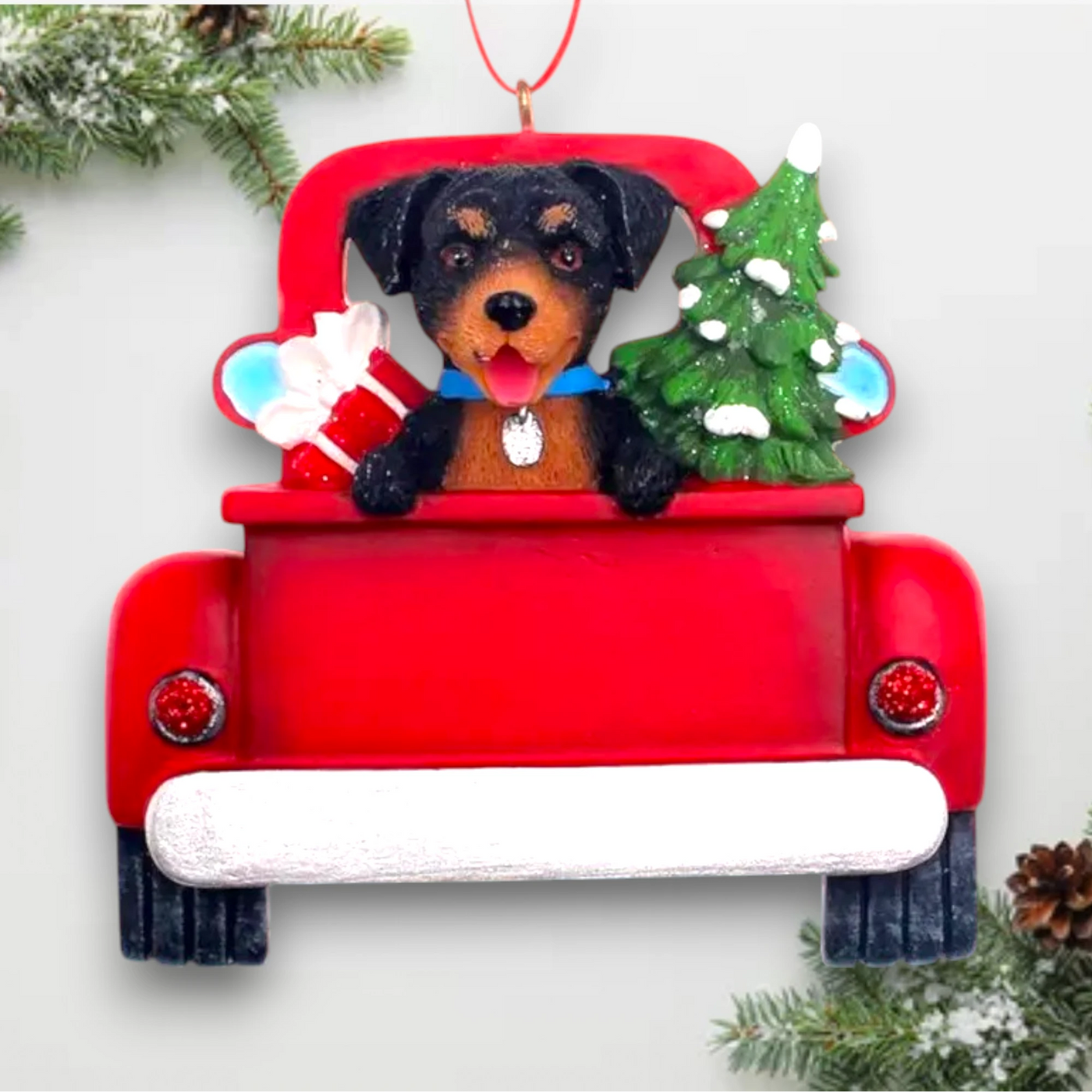 Personalized Rottweiler In Back Of Truck Christmas Ornament featuring a Rottweiler, festive red truck, Christmas tree, and gift, customizable with name and year.

