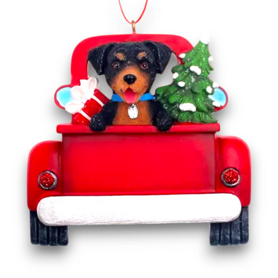 Personalized Rottweiler In Back Of Truck Christmas Ornament featuring a Rottweiler, festive red truck, Christmas tree, and gift, customizable with name and year.
