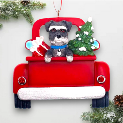 Personalized Schnauzer In Back Of Truck Christmas Ornament featuring a schnauzer, festive red truck, Christmas tree, and gift, customizable with name and year.
