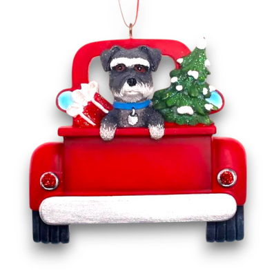 Personalized Schnauzer In Back Of Truck Christmas Ornament featuring a schnauzer, festive red truck, Christmas tree, and gift, customizable with name and year.

