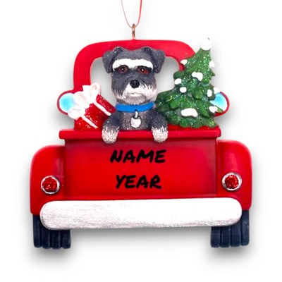 Personalized Schnauzer In Back Of Truck Christmas Ornament featuring a schnauzer, festive red truck, Christmas tree, and gift, customizable with name and year.
