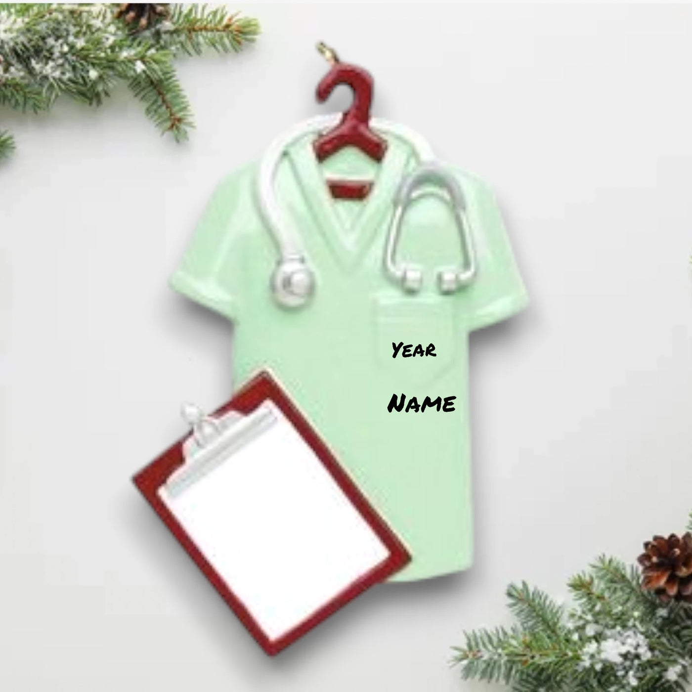 Personalized Scrubs Green Christmas Ornament featuring a scrub top, stethoscope, and clipboard with customizable name and year.