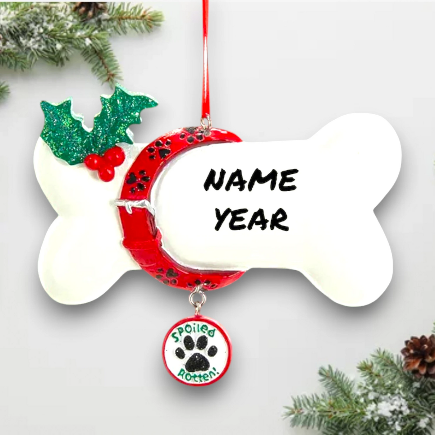 Personalized dog bone ornament with red collar, green holly, and a dangling "Spoiled Rotten" charm, customizable with your dog's name.
