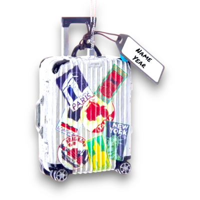 Personalized Travel Luggage Christmas Ornament featuring a suitcase with travel stickers from famous destinations like Paris, New York, and London, customizable with name and year.
