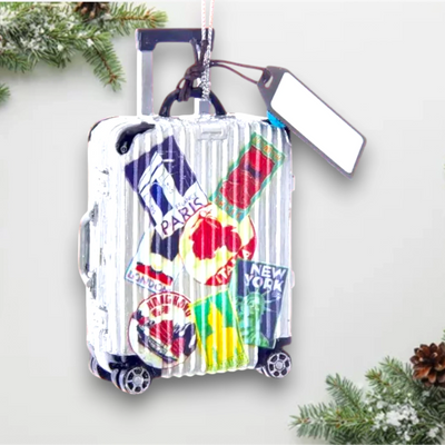 Personalized Travel Luggage Christmas Ornament featuring a suitcase with travel stickers from famous destinations like Paris, New York, and London, customizable with name and year.

